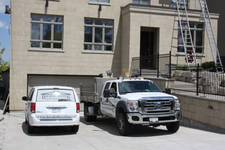 Davidoff vehicles on-site providing expert service to metal roofing project.