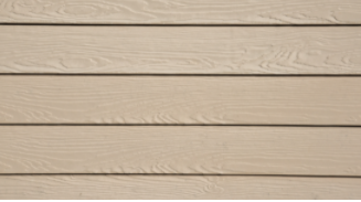 Close up of beige engineered wood siding. 
