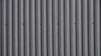 Close up of grey metal siding. 