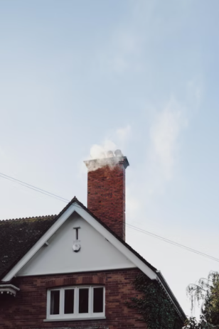 Home chimney with smoke coming out