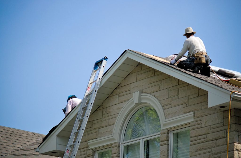 Certified roofing contractors working on a residential roof