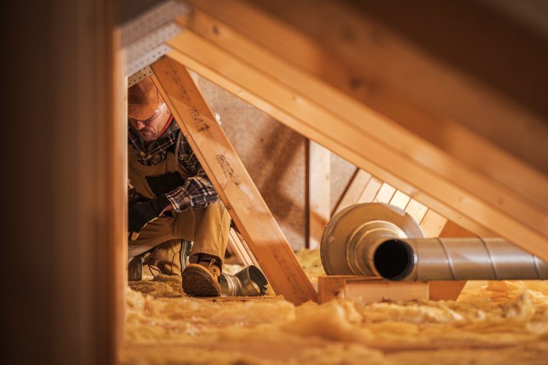 professional contractor replacing insulation in an attic
