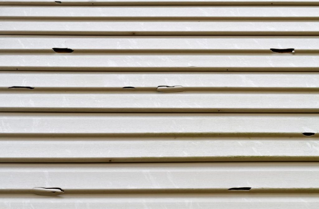 Signs of Damage to House Siding After a Storm