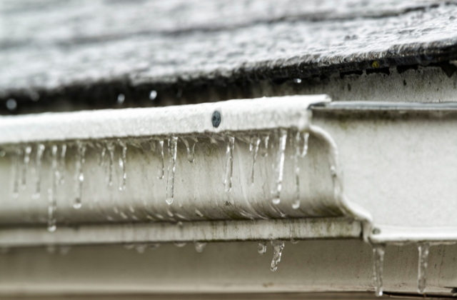 Ice buildup on gutters in winter and preventing frozen gutters with Davidoff Roofing
