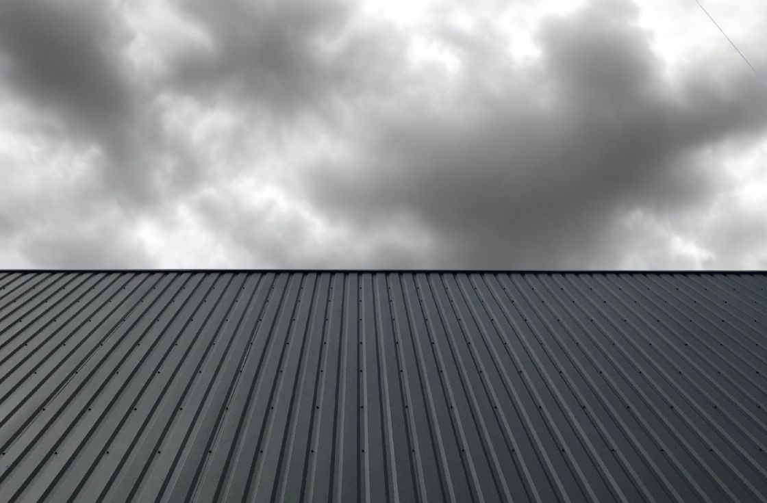 Commercial roof in Ontario being inspected after storm damage